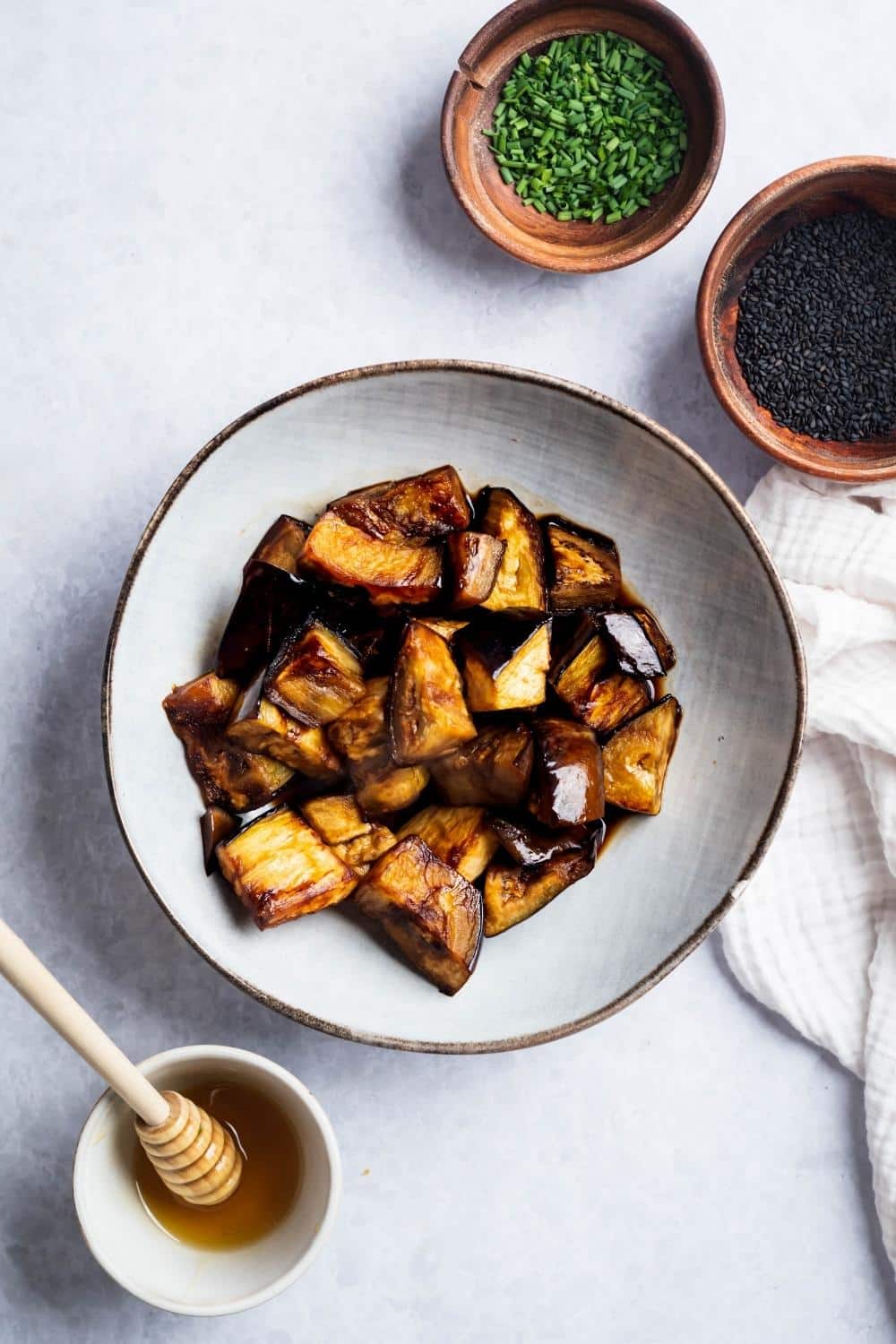 Sauteed eggplant slices on a white plate.