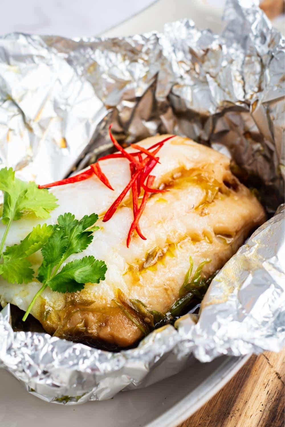 Sea bream in a tin foil basket.