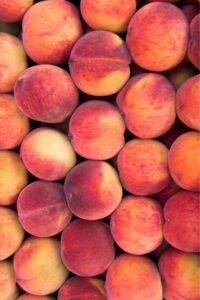 Peaches stacked on top of one another.