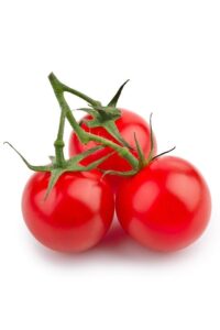 Three tomatoes connected with a vine on a white surface.