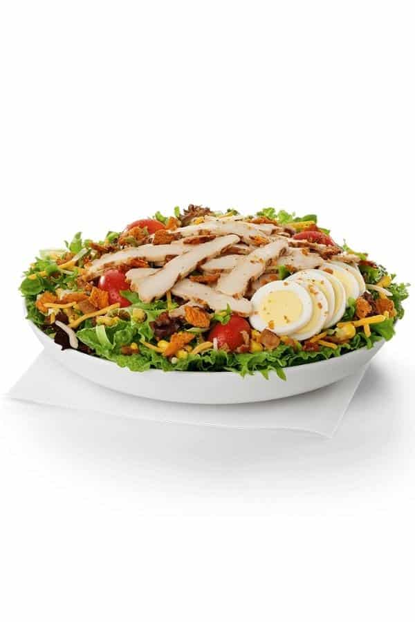 A chick fil a cobb salad in a white bowl.