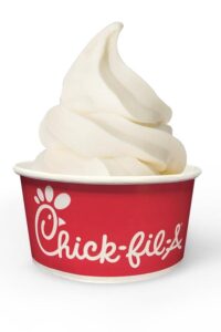 A red chick fil a cup filled with vanilla custard ice cream.