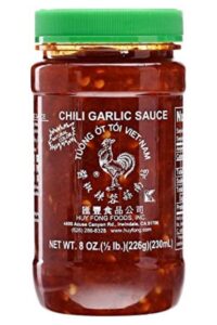 A container of chili garlic sauce.