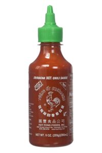 A bottle of sriracha hot chili sauce.
