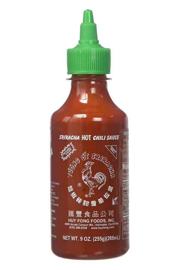 A bottle of sriracha hot chili sauce.