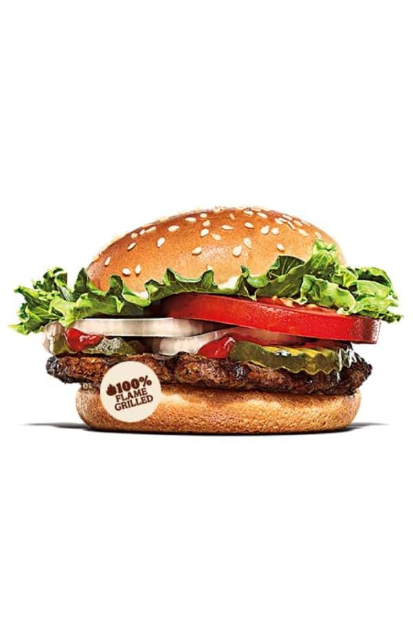 A hamburger with pickles, ketchup, onion, tomato, and lettuce.