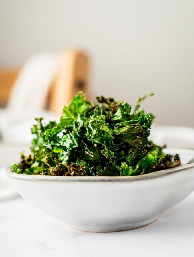 Kale chips in a white bowl.