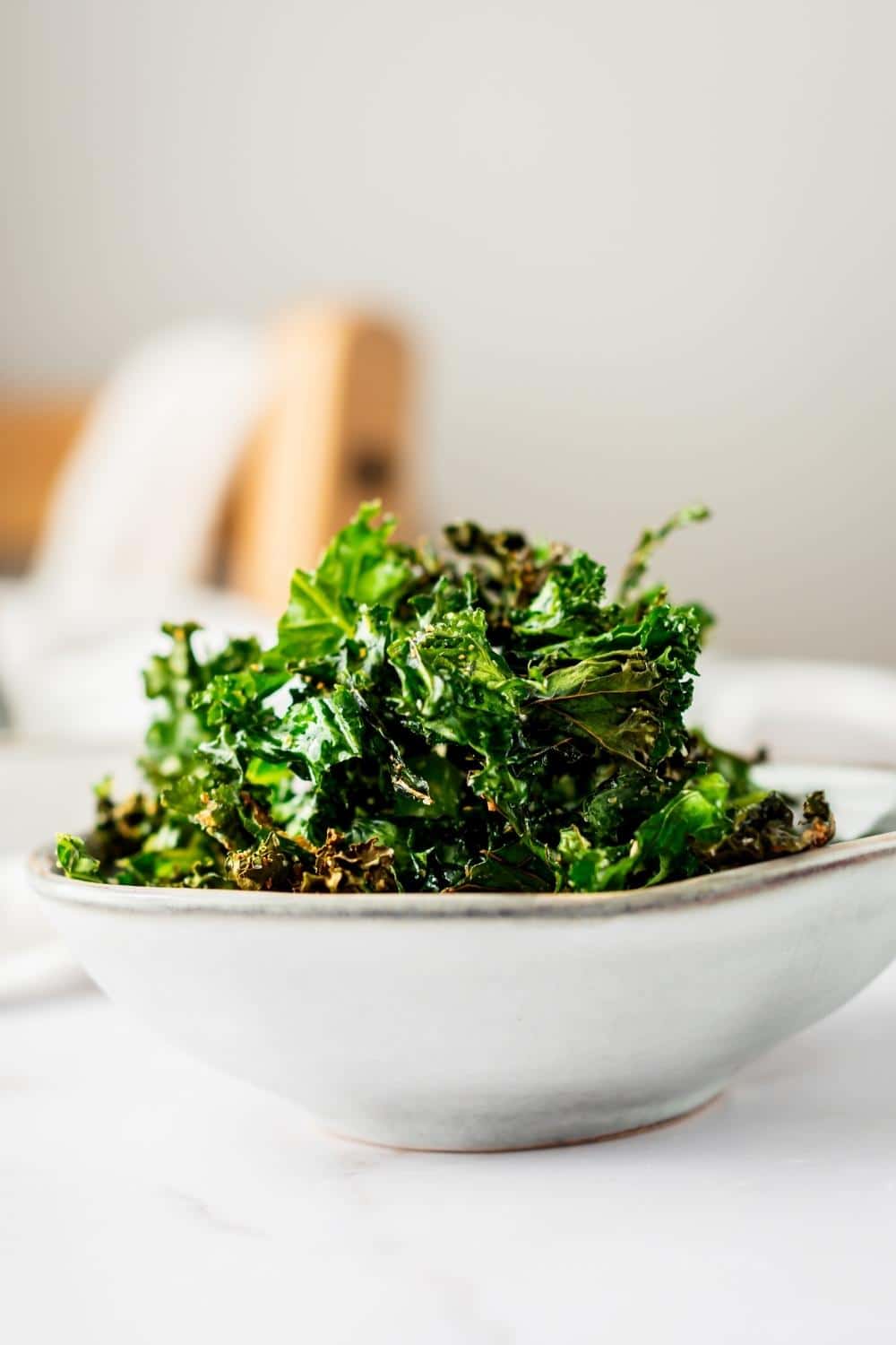 Kale chips in a white bowl.