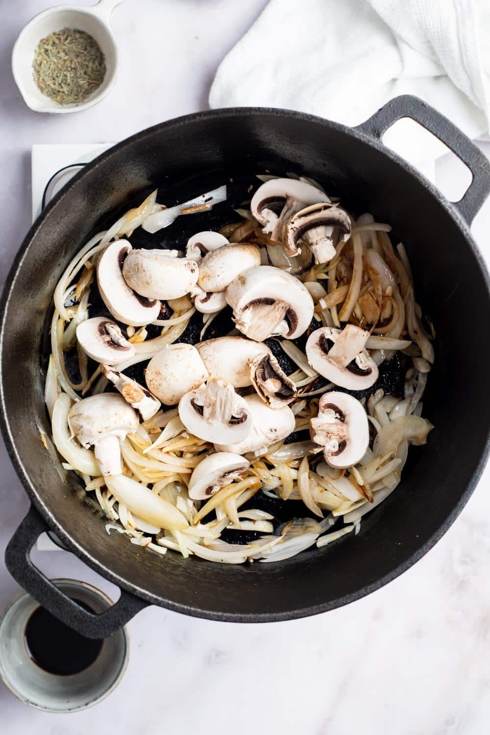 Mushrooms and onions and a Dutch oven.