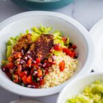 A chipolte keto bowl with pico de gallo, cauliflower rice, and chicken.