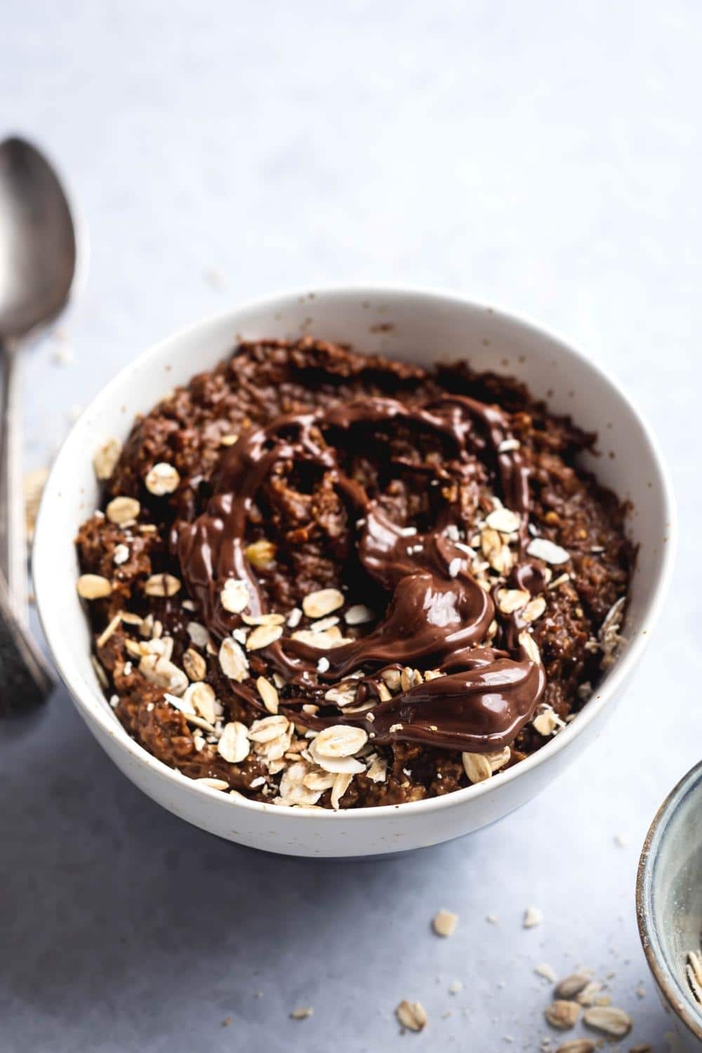 Nutella and oats on top of protien oatmeal in a bowl.