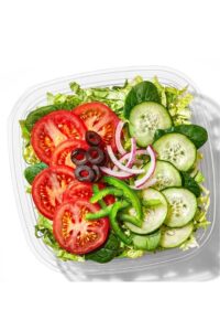 Red onion, black olives, cucumbers, and tomatoes on top of lettuce in a container.