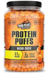 Clear tub of Twin Peaks protein puffs nacho cheese flavor.