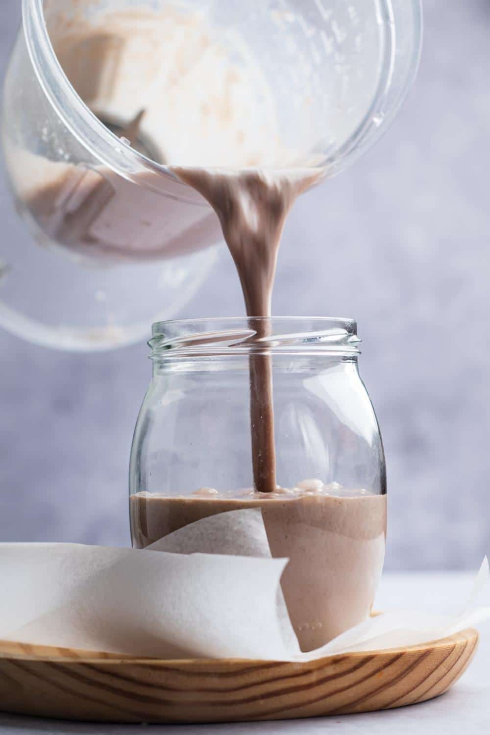 A blender pouring a mass gainer sheet into a glass.