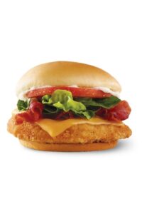 A crispy chicken sandwich with cheese, lettuce, bacon, and tomato.