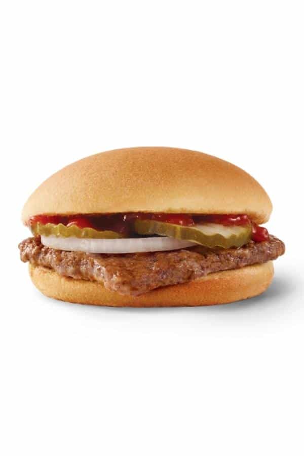 A hamburger with pickles, onion, and ketchup.