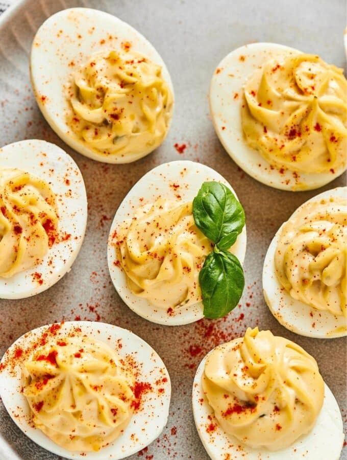 A bunch of southern deviled eggs on part of a plate.