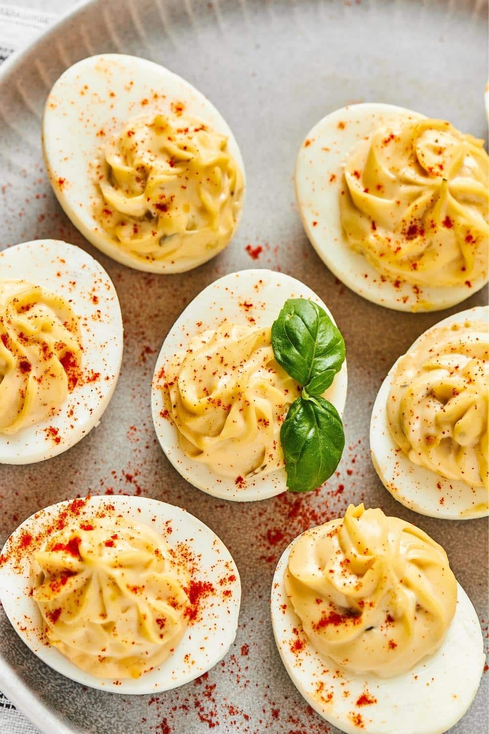 A bunch of southern deviled eggs on part of a plate.