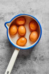 Six hard boiled eggs in a bowl.