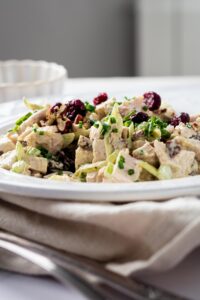 A plate with turkey salad on it.