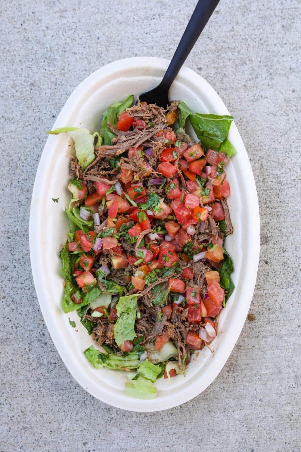 Barbocao, tomato salsa, and lettuce in a white oval bowl.