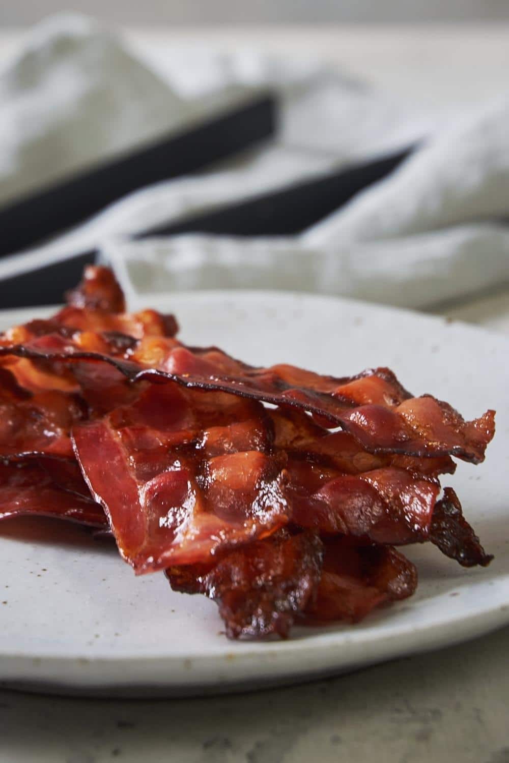 A few pieces of turkey bacon on top of one another on a plate.