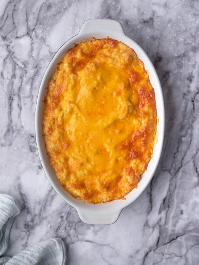 Golden and bubbly melted cheddar cheese in a baking dish.