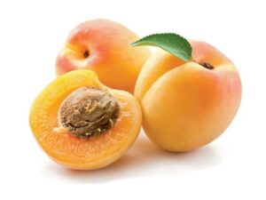 A half of an apricot in front of two whole apricots.