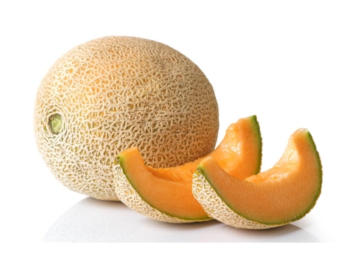 Two slices of cantaloupe in front of a whole cantaloupe.