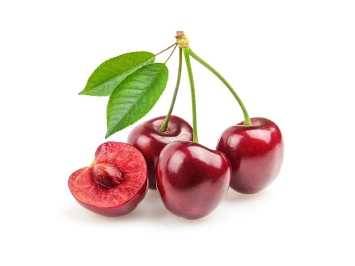 A bundle of cherries and a half of a cherry.