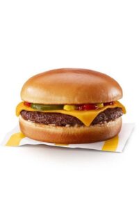 A McDonalds cheeseburger with pickle, ketchup, and mustard.