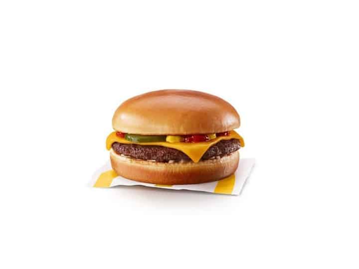 A McDonalds cheeseburger with pickle, ketchup, and mustard.