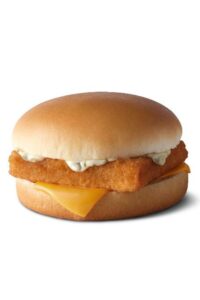 A filet of fish sandwich with tartar sauce and a slice of American cheese on it.