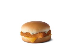 A filet of fish sandwich with tartar sauce and a slice of American cheese on it.