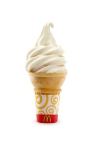 A vanilla ice cream cone with a McDonalds wrapper on it.