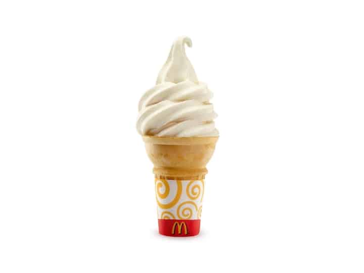 A vanilla ice cream cone with a McDonalds wrapper on it.