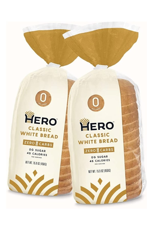 Two bags of Hero classic white bread.