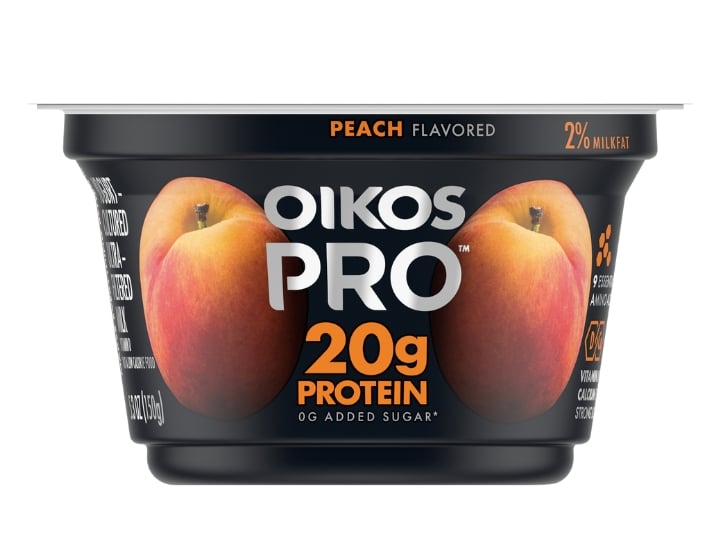 A container of Oikos Pro peach flavored yogurt.