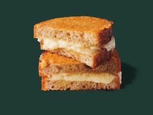 Half of a Starbucks grilled cheese on top of the other half of the grilled cheese.