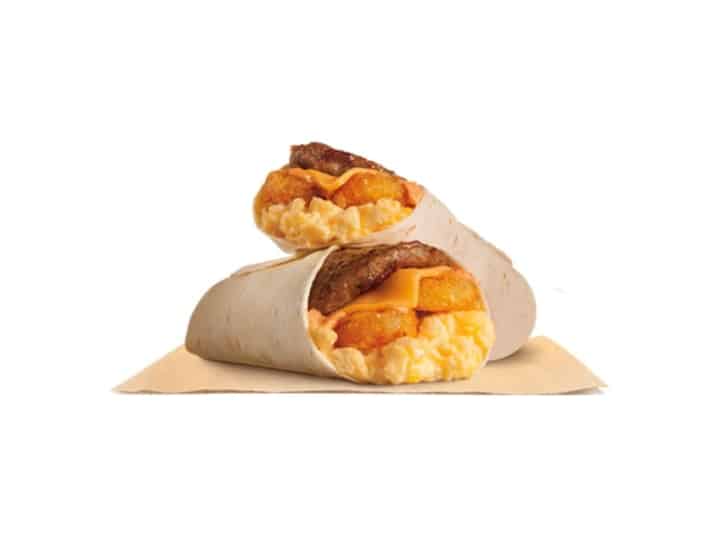 A breakfast wrap with sausage, cheese, and hashbrowns in it.