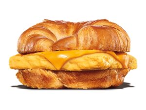 An egg and cheese on a croissant.