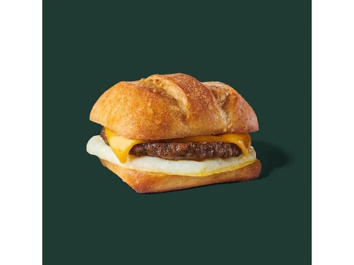 A cibatta bun with cheese, a sausage patty, and egg white.