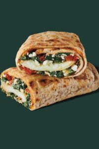 Starbucks spinach, feta, and egg white wrap cut in half stacked on top of one another.