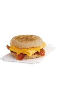 A Chick fil a bacon, egg, and cheese on an english muffin.