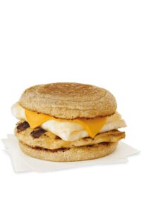 A chick fil a egg white grill with grilled chicken, cheese, and an egg white on an english muffin.
