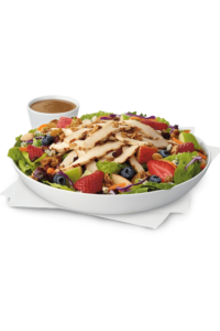 A chick fil a market salad with grilled chicken, berries, and lettuce.