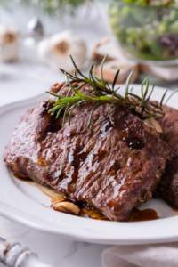 A juicy sirloin steak on a white plate.