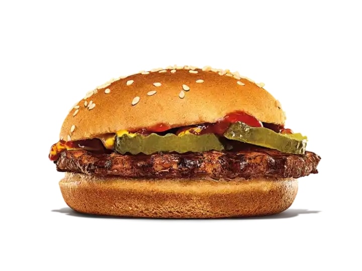 A burger king hamburger with pickles, mustard, and kethcup.