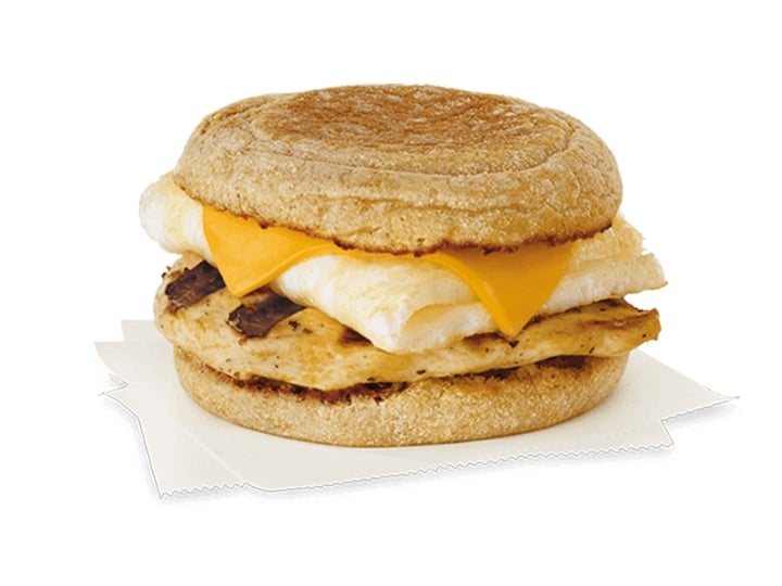 A chick fil a egg white grill with grilled chicken, cheese, and an egg white on an english muffin.