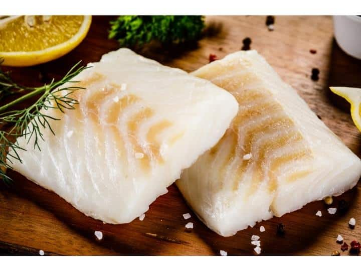 Two cod fillets on top of one antoher.